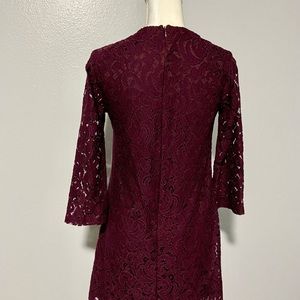 Purple lace dress, long sleeves, ties at the chest, zippered back. Pretty